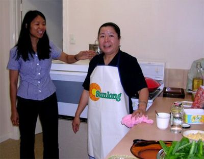 Sr Noelline cooking a Chinese meal for Sr Perpetua's farewell