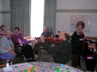Sr Elizabeth and her brother entertain nursing home residents.